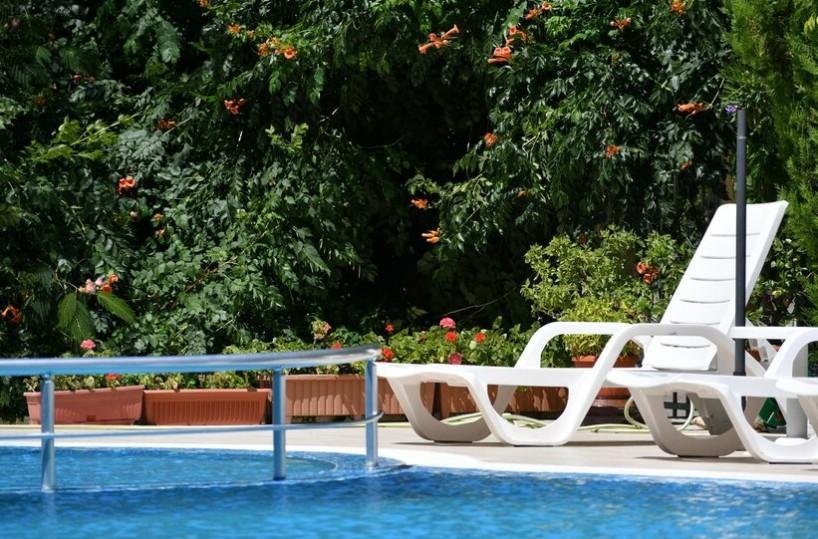 Swimming pool with green trees in background