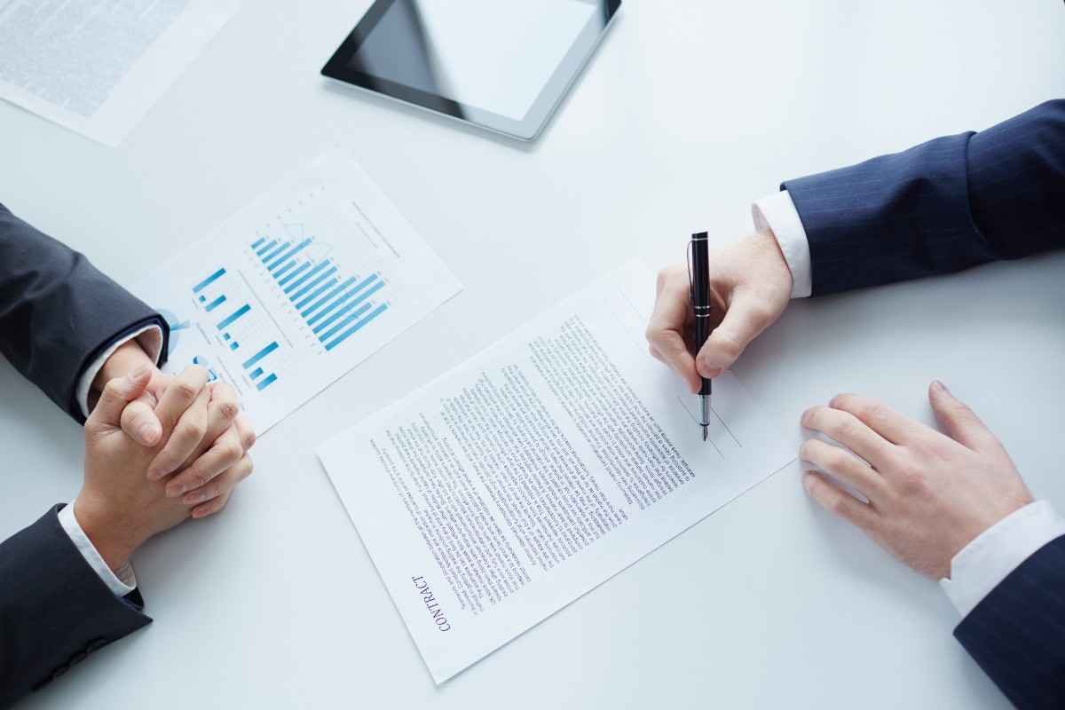 Businessman sitting signing manufacturing contract