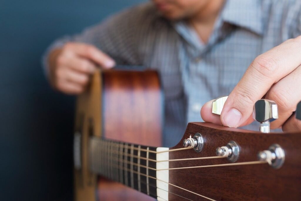 A man tuning a guitar