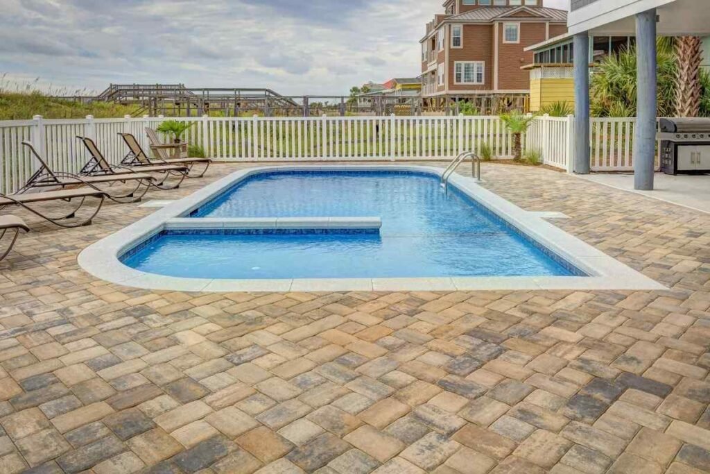 swimming pool with sitting chair aside.