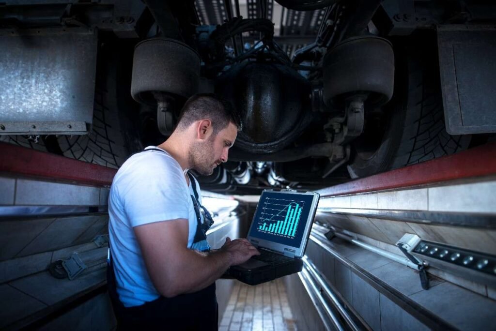 Aircraft mechanic under aircraft with diagnostic tool laptop 