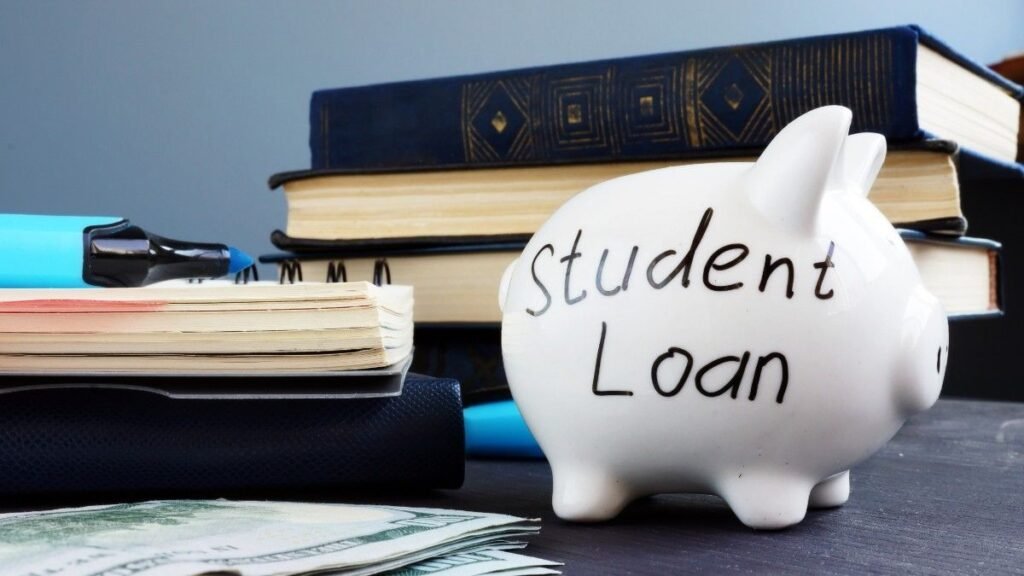 Student loan written on a piggy bank and money.