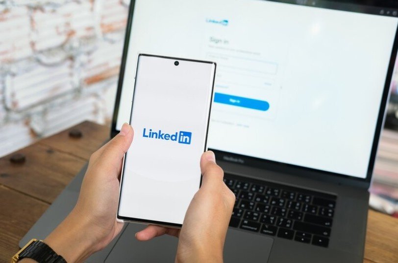 A mobile and laptop on which LinkedIn apps are opened