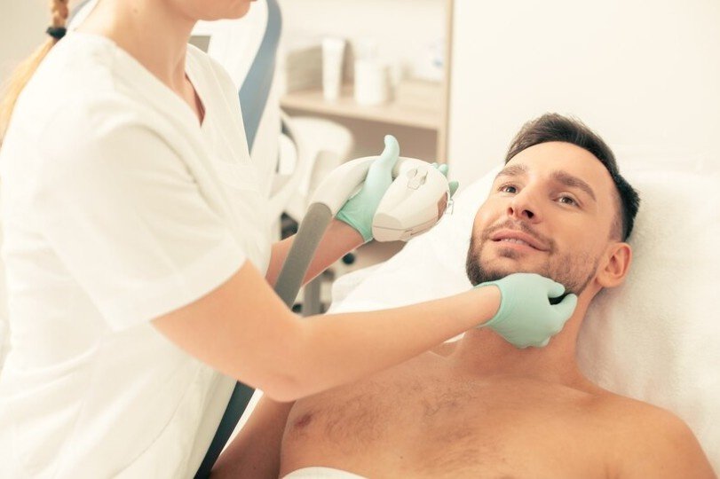 A man lying in bed undergoing treatment.