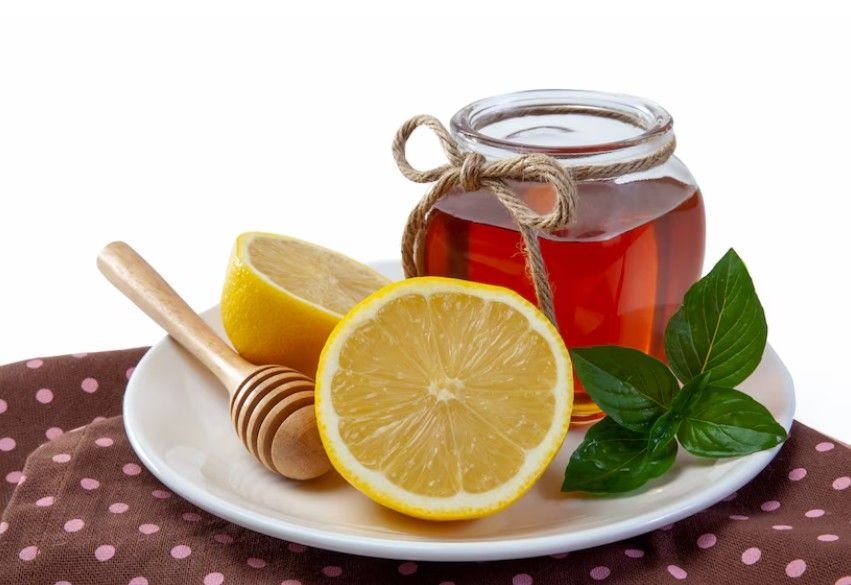 Honey, two lemons and Mint Tea in a white plat