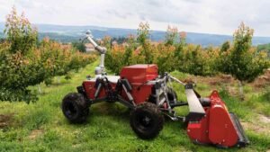 A farming robot performing his job in a field