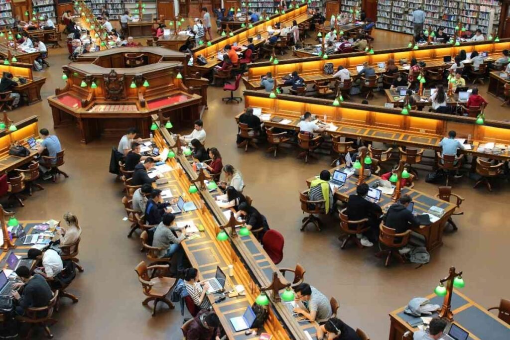 A done image of  big hall in which student are sting to their computers