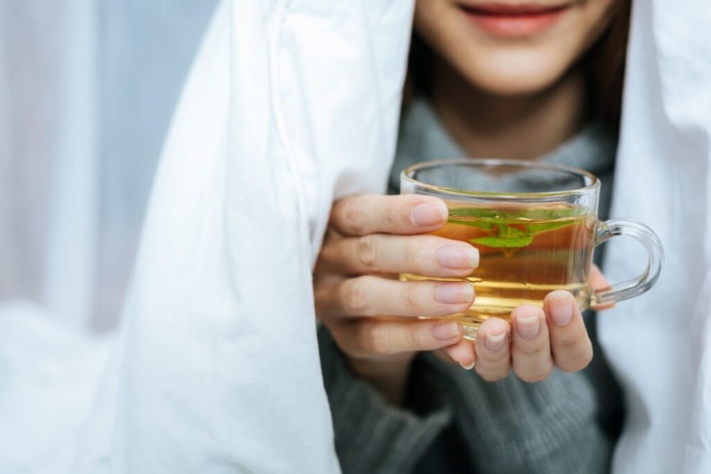 A man holding Honey Citrus Mint Tea cup