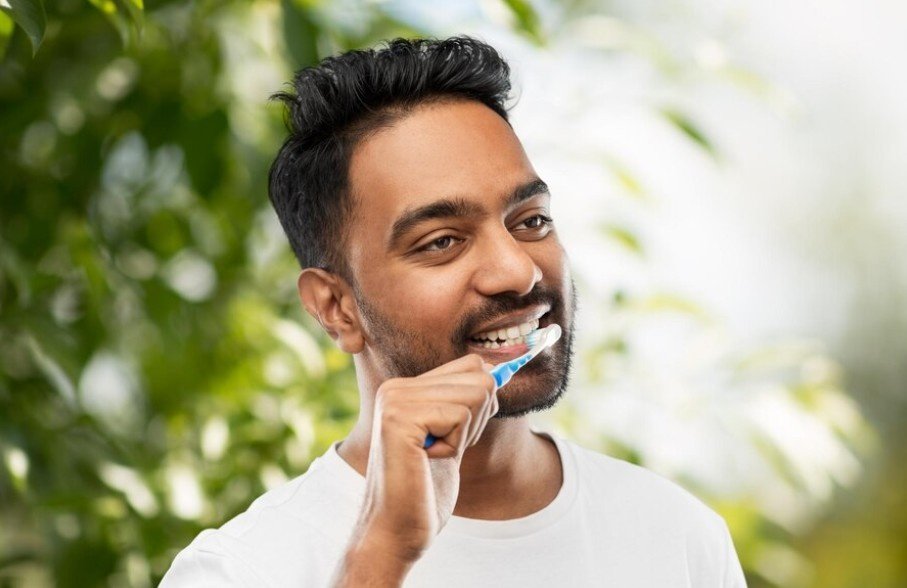 A man brushing teeth.